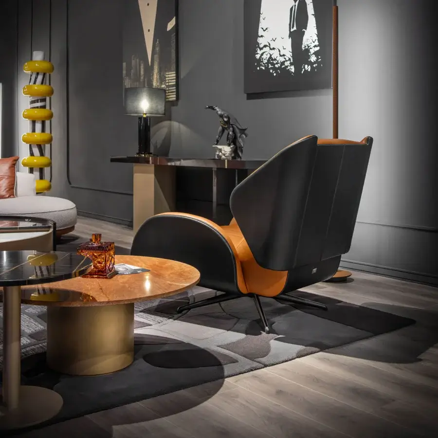 Elegant WAYNE Enterprises WE-015 lounge chair crafted in Italy with dark gray fabric or leather and warm orange-brown accents