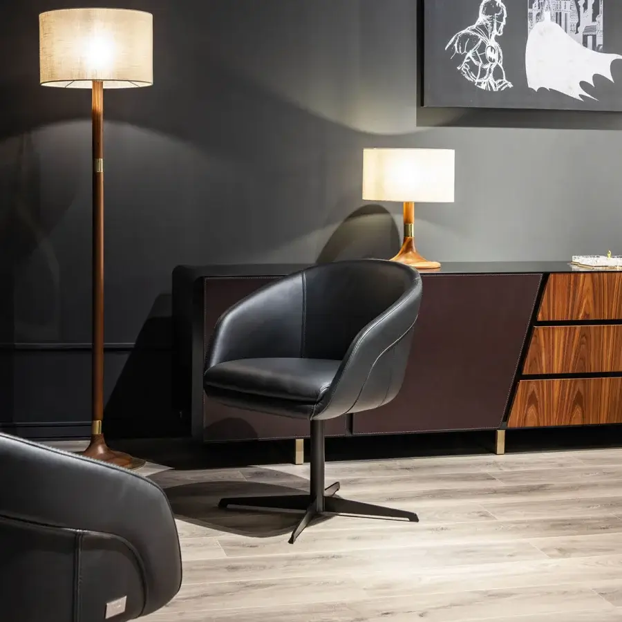 Elegant Wayne Enterprises WE-137 armchair with sleek black leather upholstery and dark matte metal swivel base