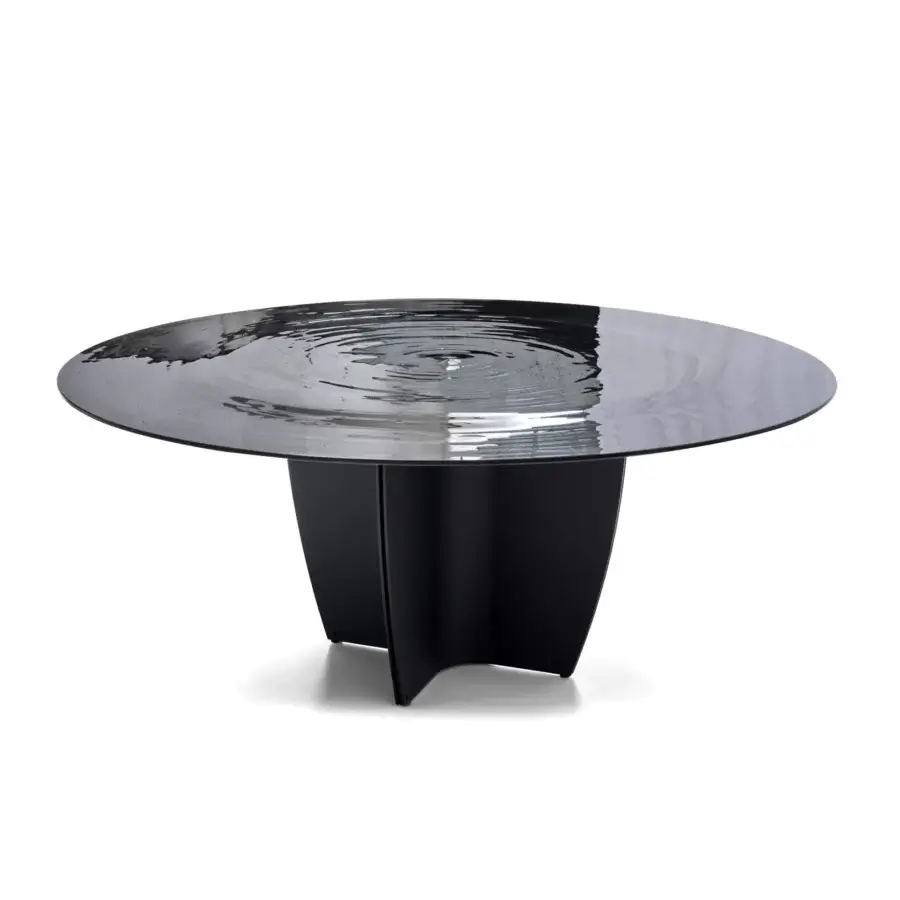 Elegant Arketipo Gambler table with a bold circular glass tabletop and uniquely faceted dark-toned base