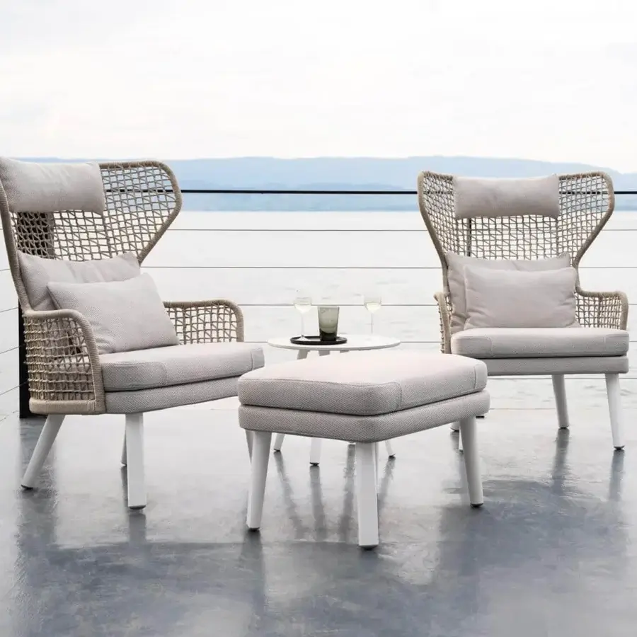 Distinguished Varaschin Emma Bergere lounge chair with iconic rope weaving and light gray textile cushions in a light matte Iroko wood finish