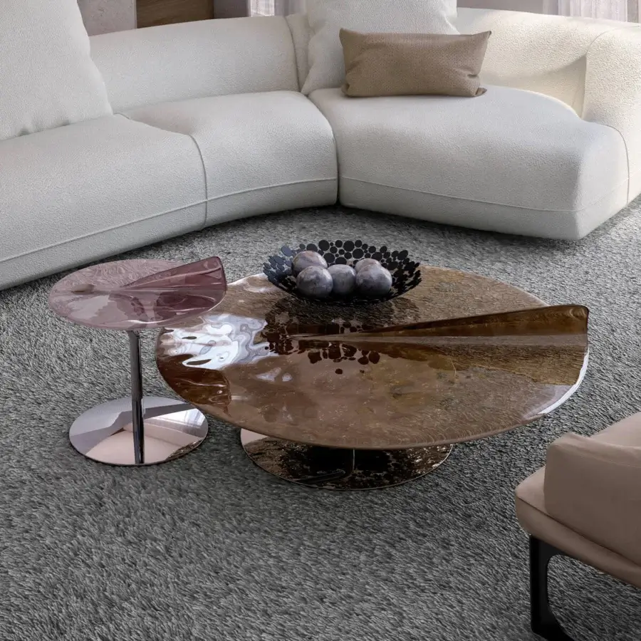 Distinguished Arketipo Maverick coffee table with translucent tabletop and polished metal base exhibiting a rose tone with high-gloss finish
