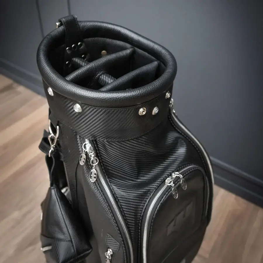 Exclusive WAYNE Enterprises WE-GOLF 048 golf bag in black leather and textured carbon fiber leather with silver zippers and a nickel finish logo