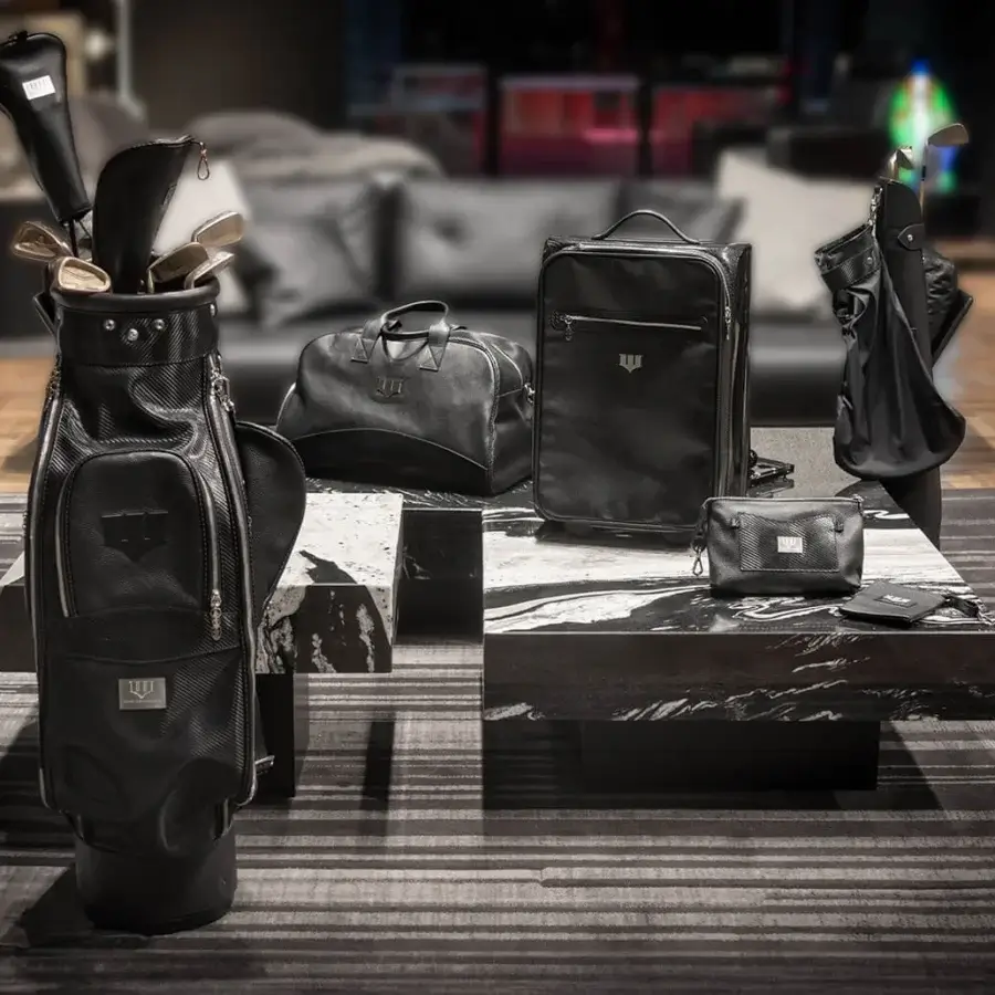 Elegant WAYNE Enterprises WE-GOLF 048 golf bag crafted in black leather and textured Carbon Fiber leather with silver-toned metallic hardware