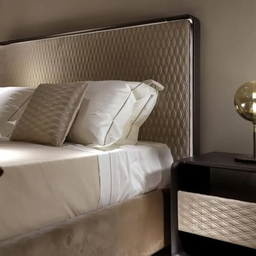 Lavish Reflex Oh bed with light brown quilted textile and shaped wooden frame built with bronze finish and subtle illumination