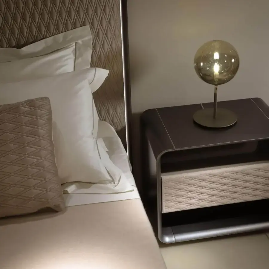 Superior Reflex Oh bed with neutral quilted fabric and diamond pattern, built with bronze finished shaped wood and subtle lighting