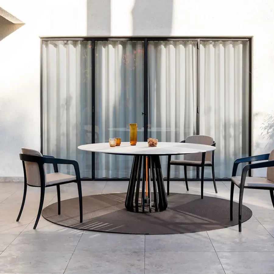 Elegant Royal Botania Furniz table with a light beige matte tabletop and dark gray intricately woven metal base
