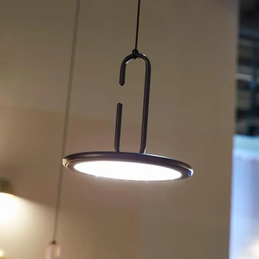 Elegant Penta Clip suspension lamp with dark metal structure and circular light framed in sleek finish
