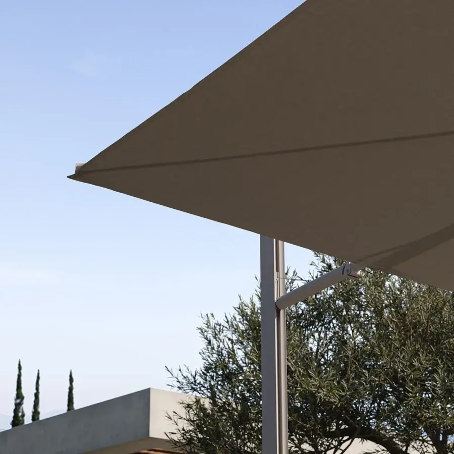 Superior Royal Botania Solaz umbrella with a geometrically-shaped neutral beige textile canopy and sleek silver-finished metal pole