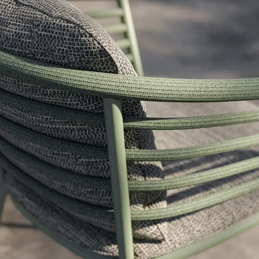 Elegant Royal Botania Archy armchair with a gracefully curved matte Sage metal frame and muted gray woven Batyline seat