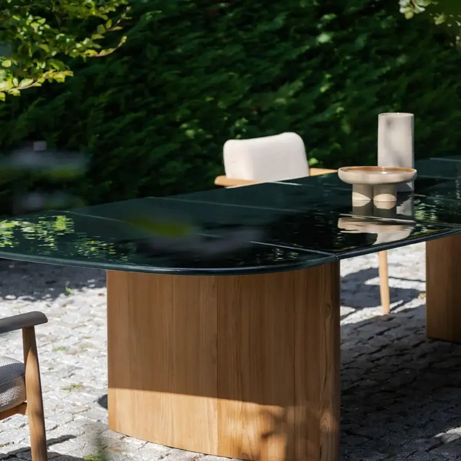 Distinguished Royal Botania Regaliz table with a dark green glass top crafted with a unique melting technique and satin finished teak base