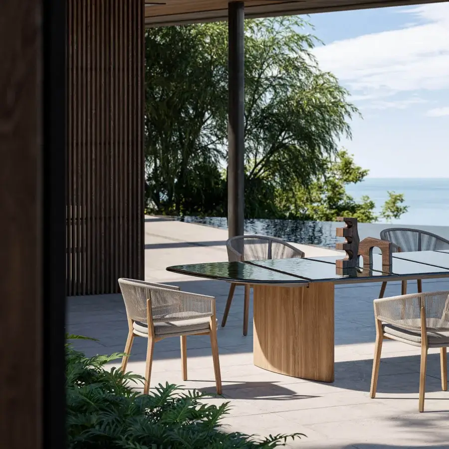 Distinguished Royal Botania Regaliz table with dark brown glass and a substantial teak base showcasing visible grain