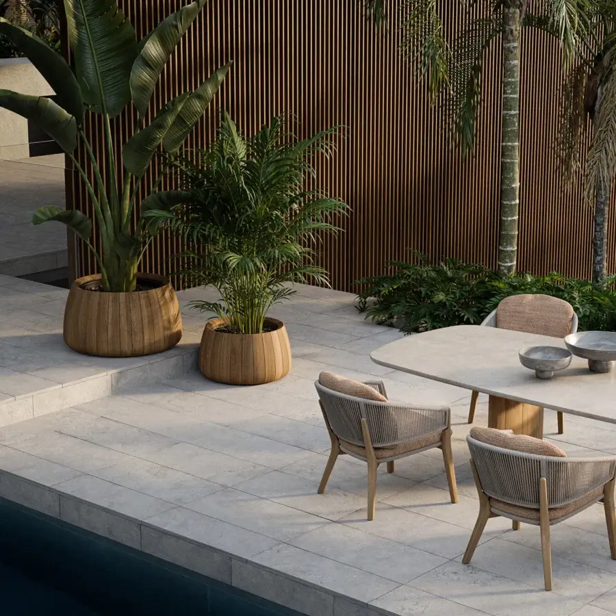 Distinguished Royal Botania Regaliz table with oval teak base and pebble-finished glass tabletop presenting a subtle off-white hue