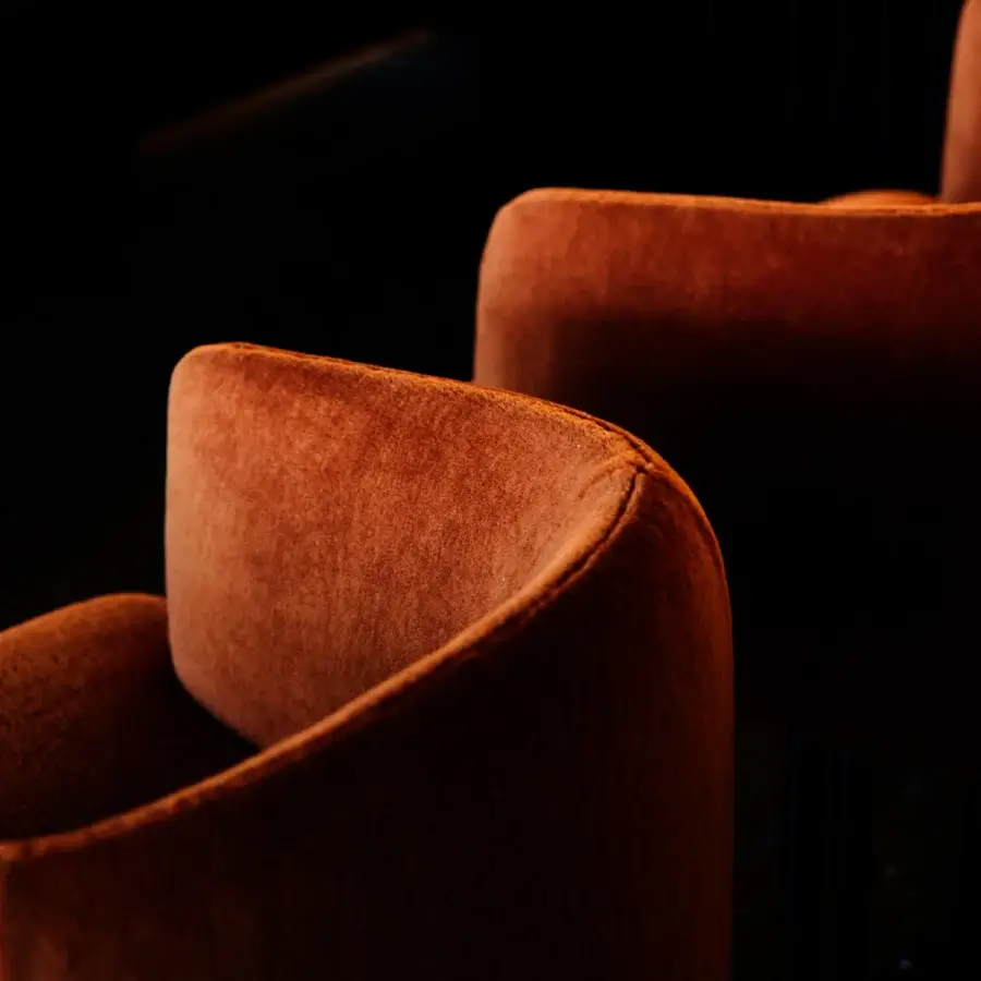 Lavish Giorgetti Hero lounge chair crafted in reddish-orange fabric with two-tone leather and canaletto walnut finish