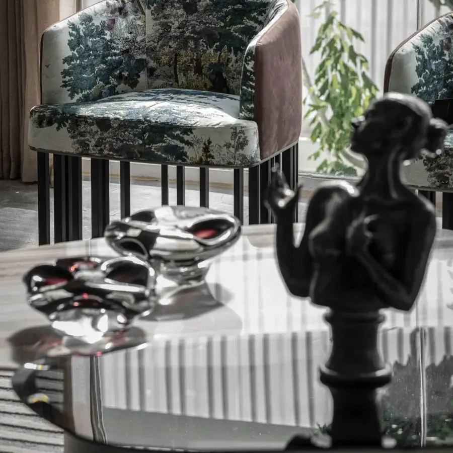 Distinguished Giorgetti Hero lounge chair with landscape print in green, blue, and brown paired with dark brown leather and canaletto walnut base