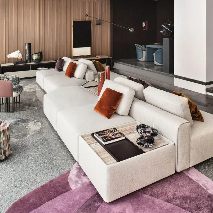 Superior Giorgetti Hero lounge chair upholstered in neutral beige fabric with burnt orange, plum, and terracotta cushions and canaletto walnut base