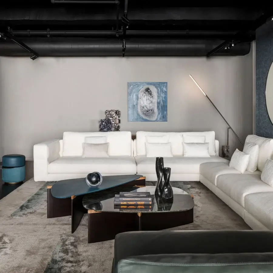 Distinguished Giorgetti Griffe coffee table with an asymmetrical Canaletto walnut base and pau ferro details in a dark-toned matte finish