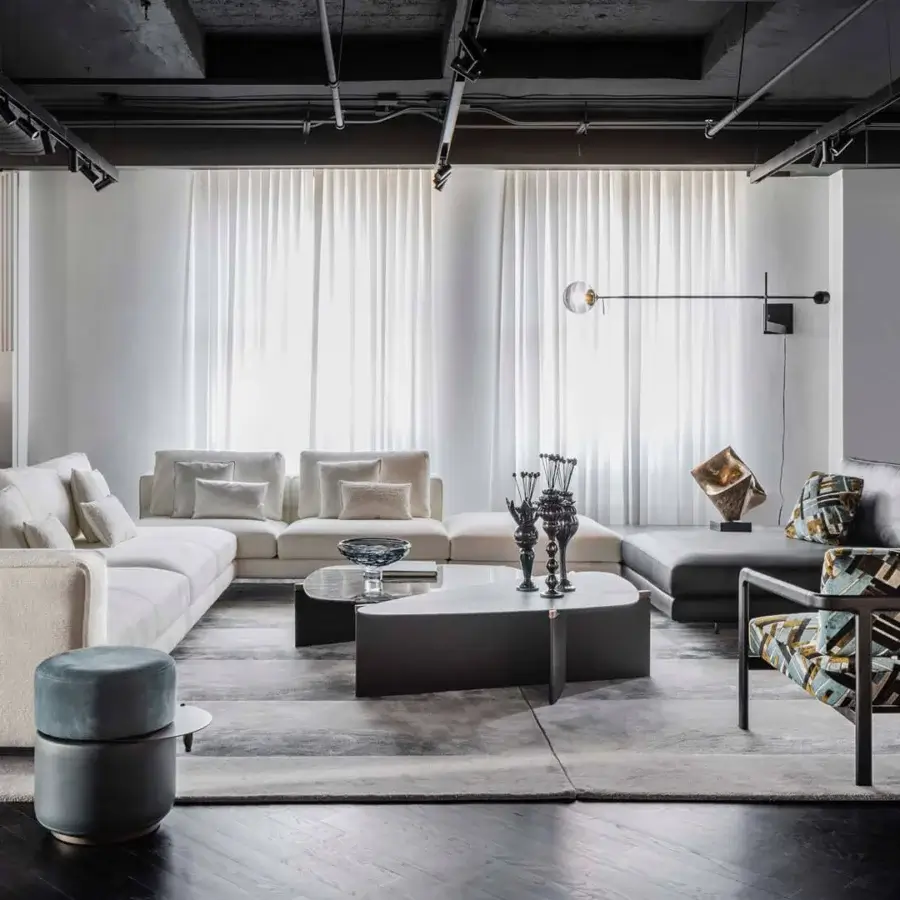 Refined Giorgetti Griffe coffee table with an asymmetrical Canaletto walnut base and dark gray-brown matte tabletop built with pau ferro details