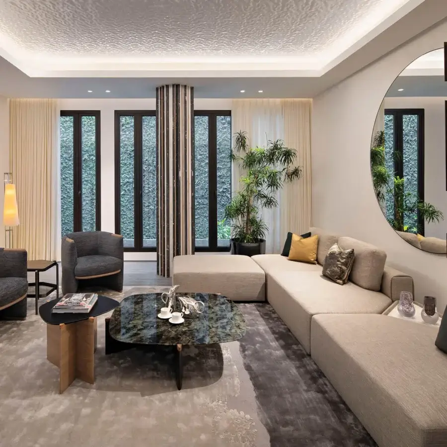 Superior Giorgetti Griffe coffee table with an irregular dark polished marble top and satin Canaletto walnut with pau ferro accents
