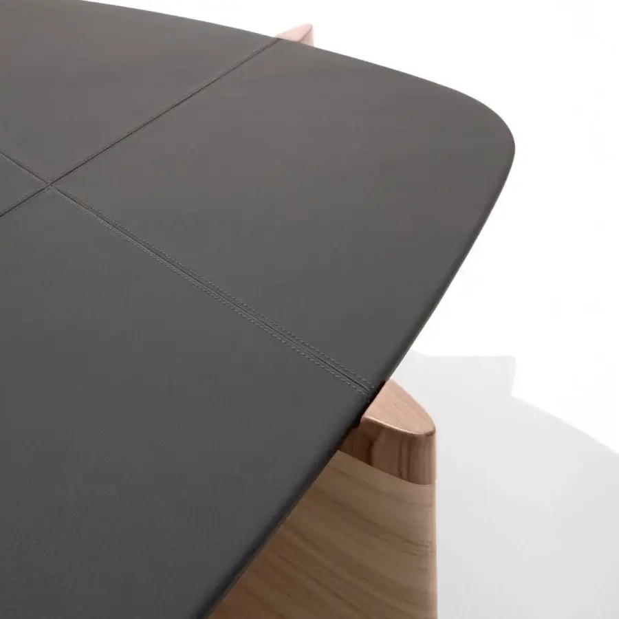 Exceptional Giorgetti Griffe coffee table with dark charcoal leather tabletop and asymmetrical Canaletto walnut finish