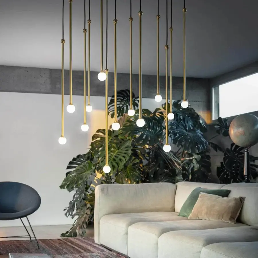 Distinguished Penta Storm suspension lamp with slender golden varnished metal rods suspended in black cords creating a contemporary aesthetic