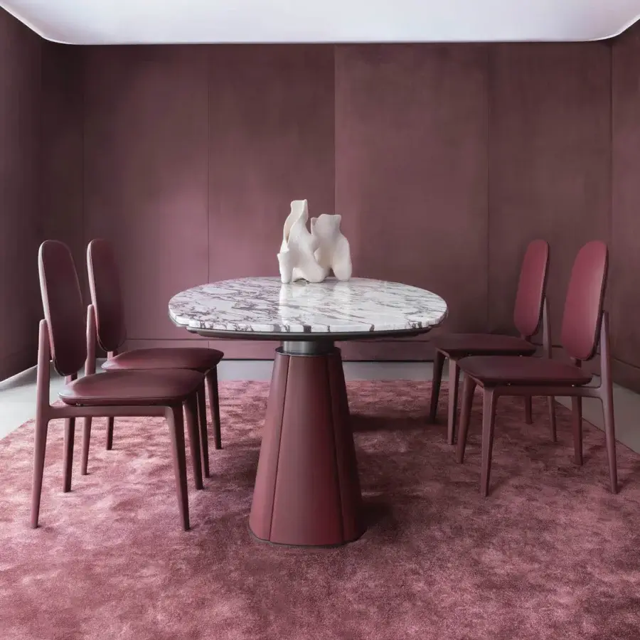 Distinguished Giorgetti Floria table with a polished marble top exhibiting grey and white veining plus a deep burgundy leather base