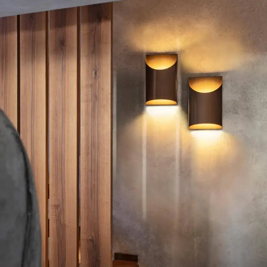 Elegant Penta Aprile wall lamp crafted with cylindrical metal form in brushed bronze finish emitting warm glow
