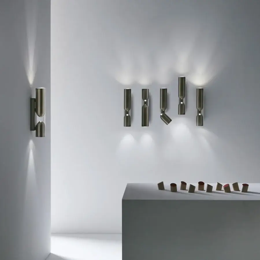 Distinguished Penta Clash wall lamp uniting lightness with strength in transparent glass and brushed bronze construction