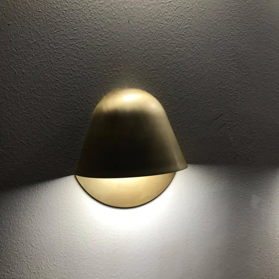 Superior Penta Enoki wall lamp crafted in matt varnished metal with gold finish exhibiting a minimalist dome form and diffused glow