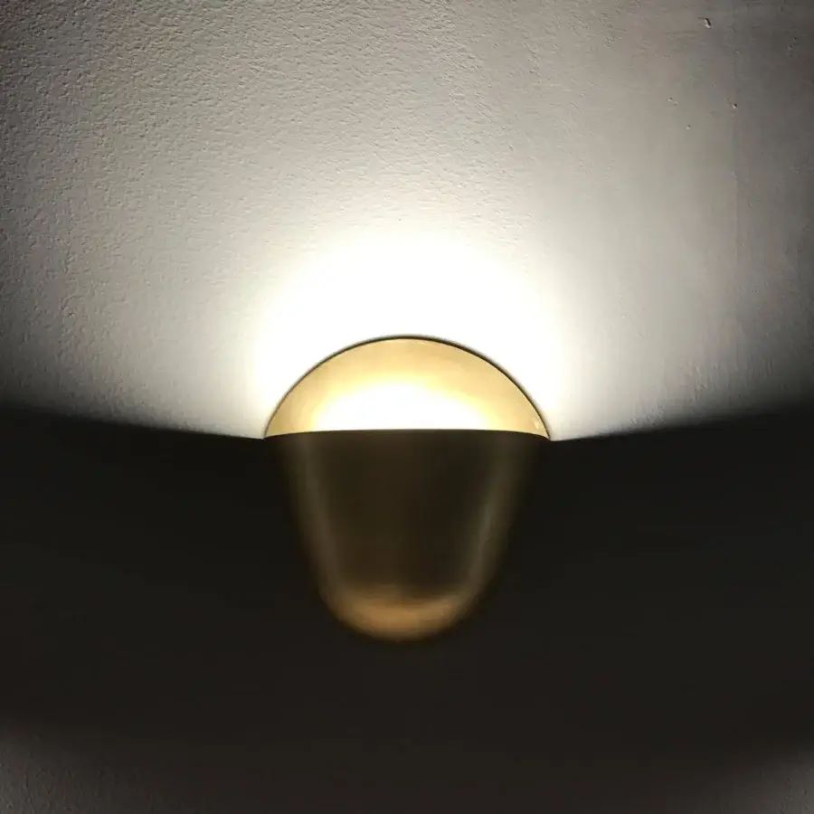 Exceptional Penta Enoki wall lamp crafted in matt varnished metal with a gold finish creating a bright semi-circular glow