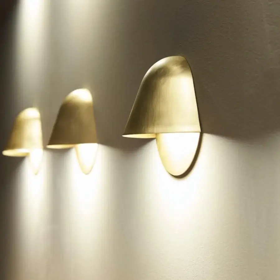 Exceptional Penta Enoki wall lamp in matt varnished metal casting a warm glow with a rich gold color