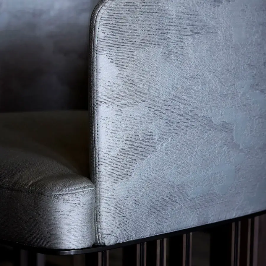 Distinguished Giorgetti Hero chair with muted gray textured fabric upholstery and a canaletto walnut base crafted with a matte finish
