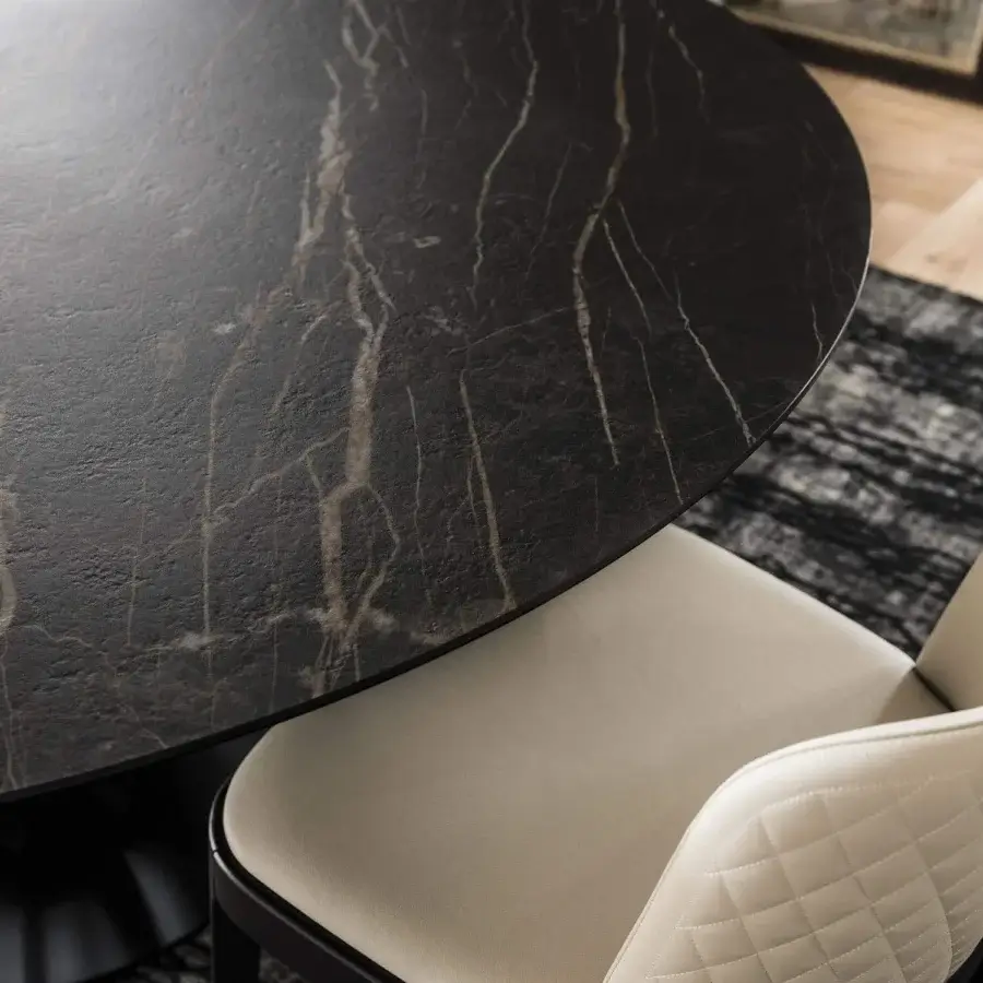 Elegant Cattelan Italia Soho Keramik table with a black embossed steel base and matt Portoro Marmi ceramic top showcasing dark veining