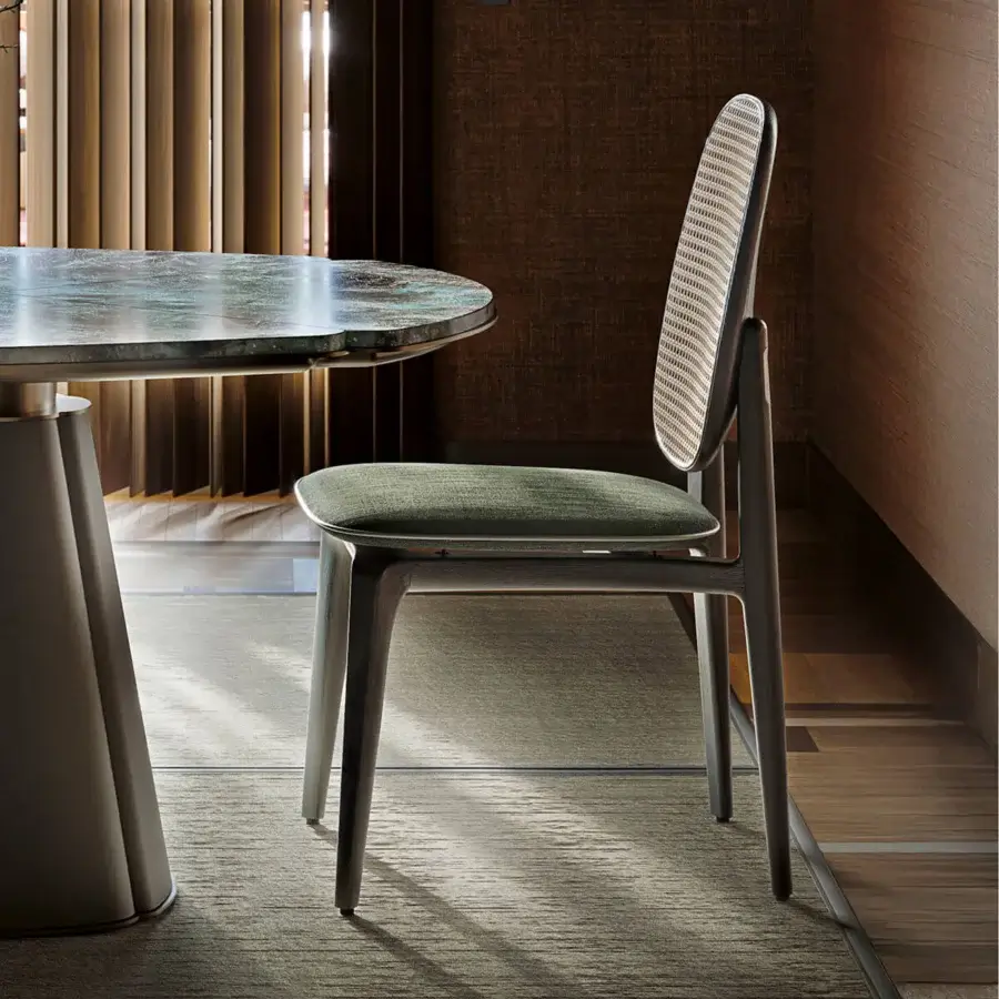 Distinguished Giorgetti Plume chair crafted with solid ash wood, muted green textile upholstery, and a natural Viena straw backrest with satin finish