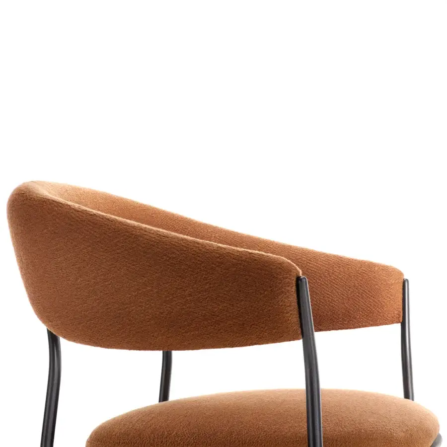 Elegant MDF Italia Archie armchair with organically curved form upholstered in warm earthy brown textile and dark-toned metal structure