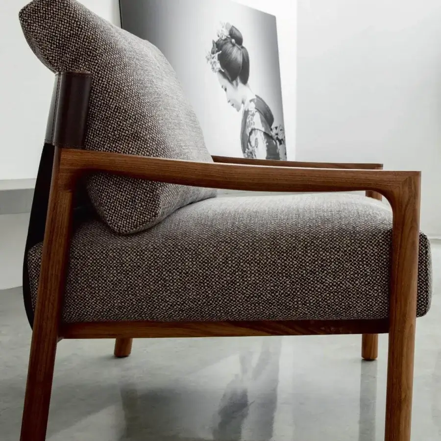 Distinguished Porada Vera lounge chair with Canaletto walnut frame and speckled gray-brown Cuoietto leather accents