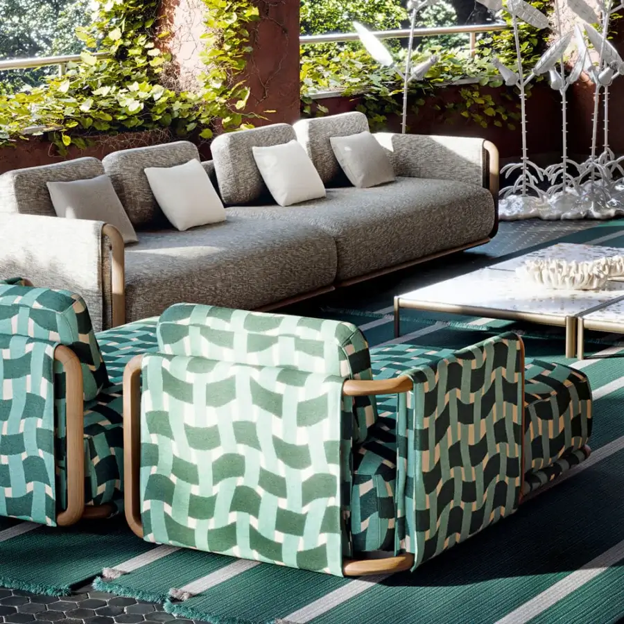 Superior Giorgetti Moorea sectional with painted teak, stainless steel and light gray cushions upholstered in patterned green and beige textile