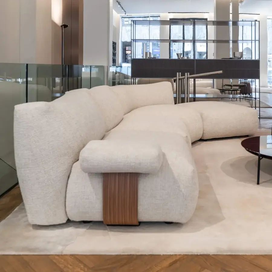 Exclusive MDF Italia Goom sectional with sculpted form, textured off-white woven fabric upholstery and layered medium-brown satin finished wood base