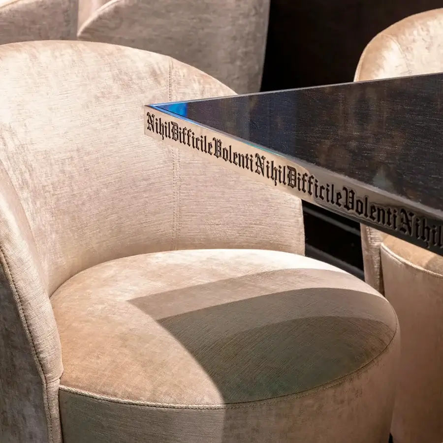 Refined Sicis Celebrity lounge chair in light beige textile with silver-grey metal base and enveloping silhouette