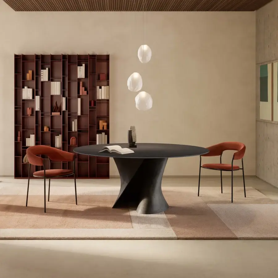 Elegant MDF Italia S table crafted in white concrete with an extra-clear glass top exhibiting dynamic curves