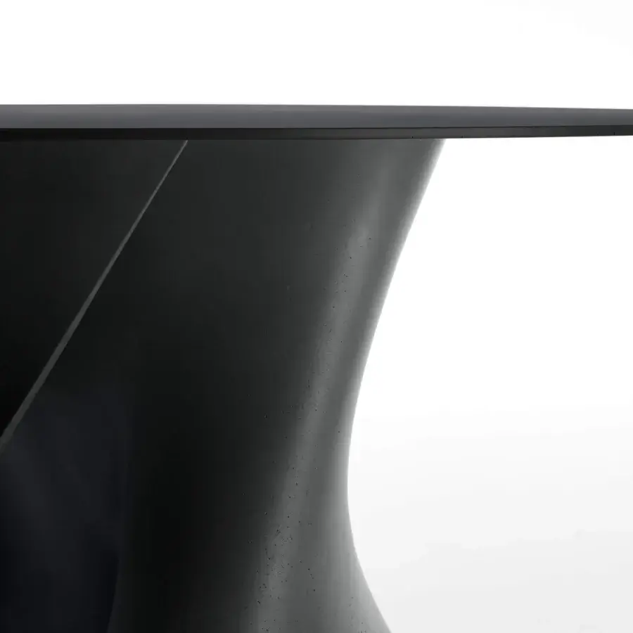 Distinguished MDF Italia S table crafted in anthracite concrete with extra-clear glass, exhibiting sculptural curves and a minimalist finish