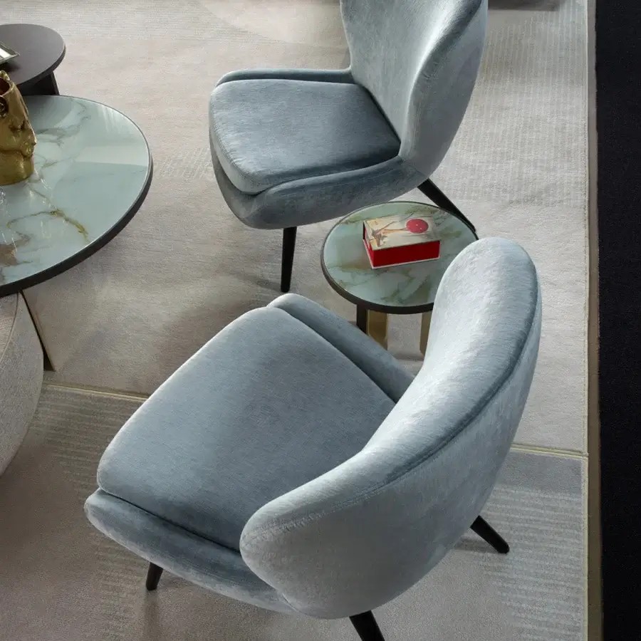 Distinguished Sicis Niels lounge chair with plush dusty blue textile and elegantly tapered wood legs