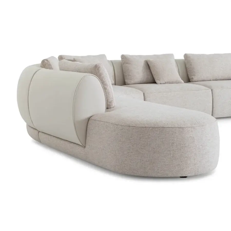 Distinguished Sicis Botero sectional with soft curved silhouette upholstered in neutral beige textile and contrasting leather-like armrests with removable finish