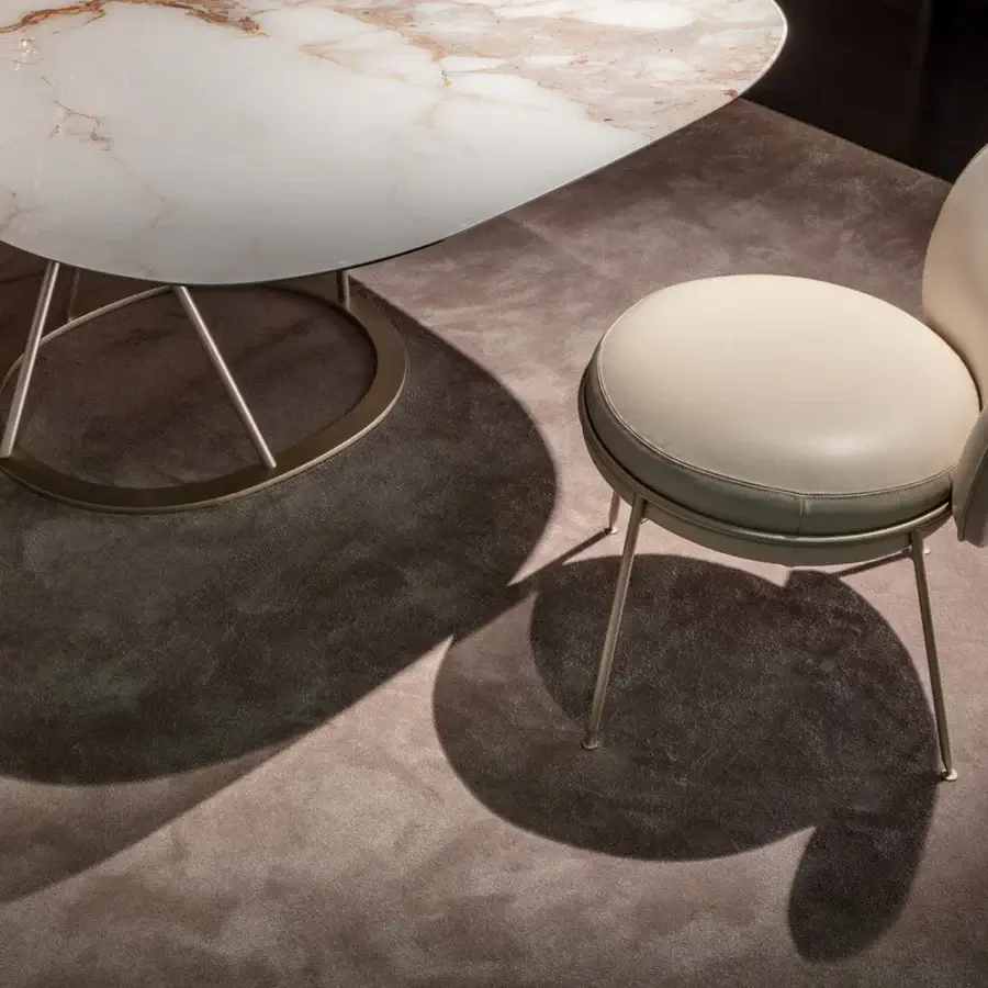 Captivating Sicis Amaretto chair with gently curved silhouette and light beige textile upholstery crafted with a brushed metal frame