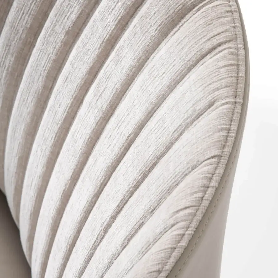 Superior Giorgetti Bicolette chair with vertical stitching and soft contours in a light neutral fabric upholstery