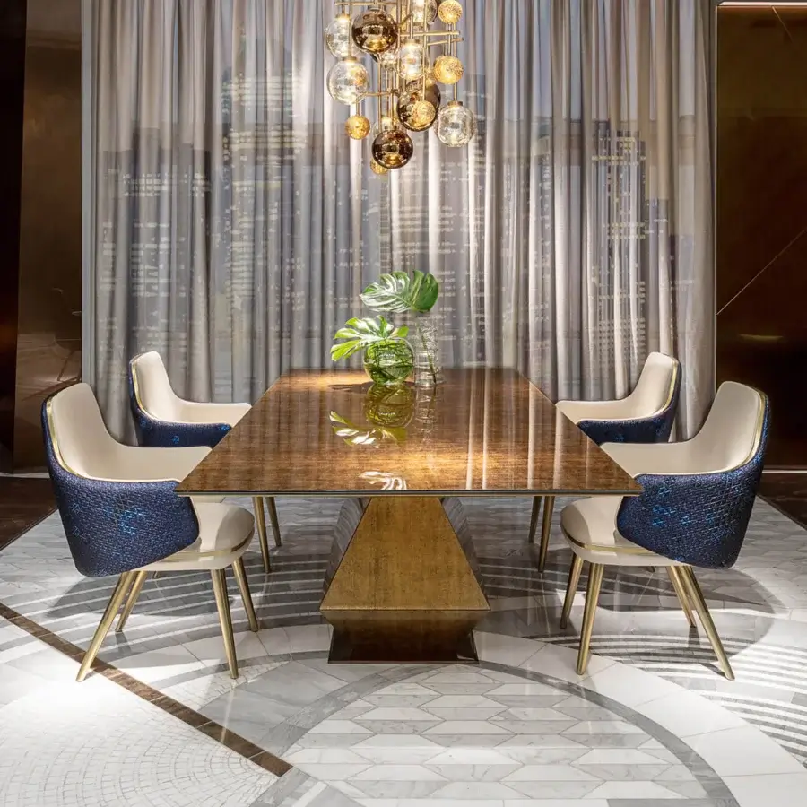Lavish Sicis Monrò armchair with enveloping form, deep blue scaled textile and polished golden-toned metal frame