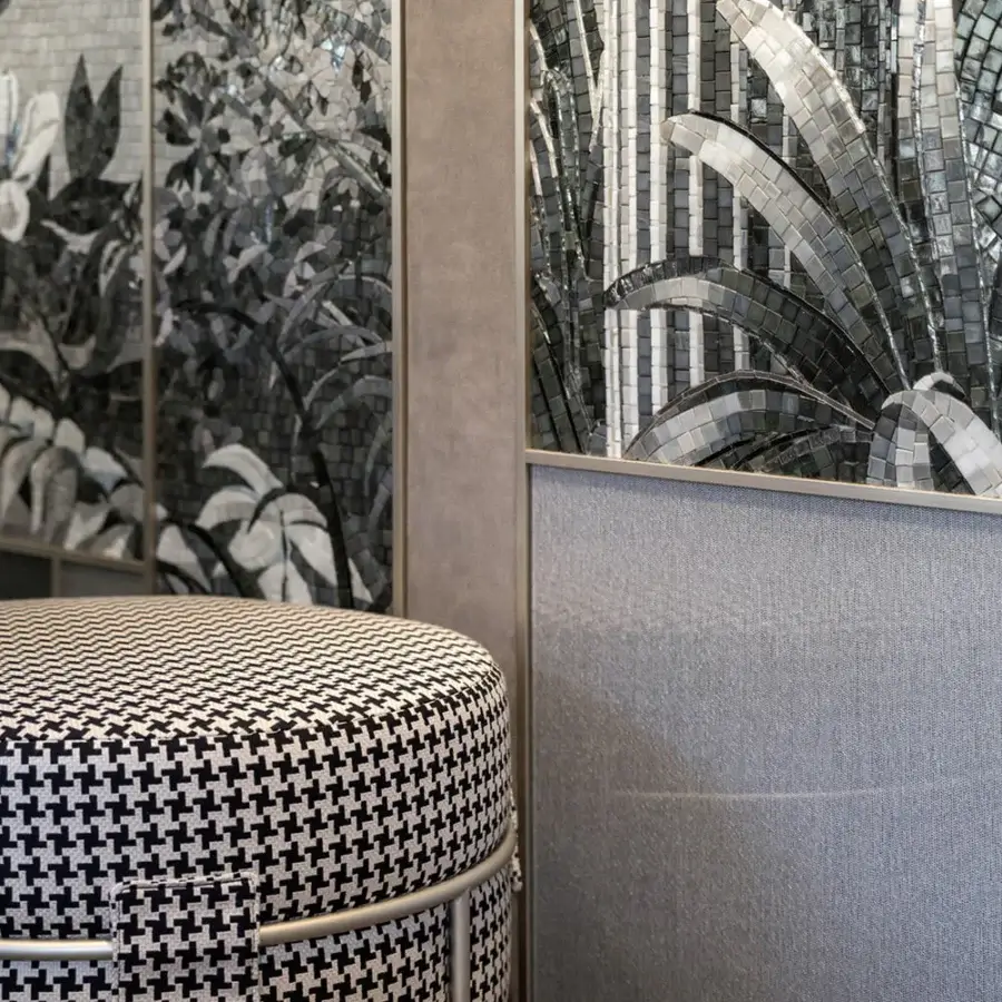 Superior Sicis Amaretto ottoman with cylindrical form upholstered in black and white houndstooth fabric and coated metal base