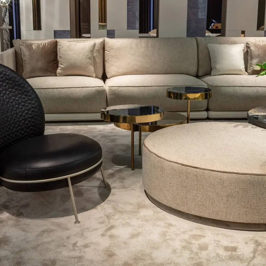 Distinguished Sicis Chamaleon low round ottoman upholstered in beige textile with a refined gold-toned metallic base