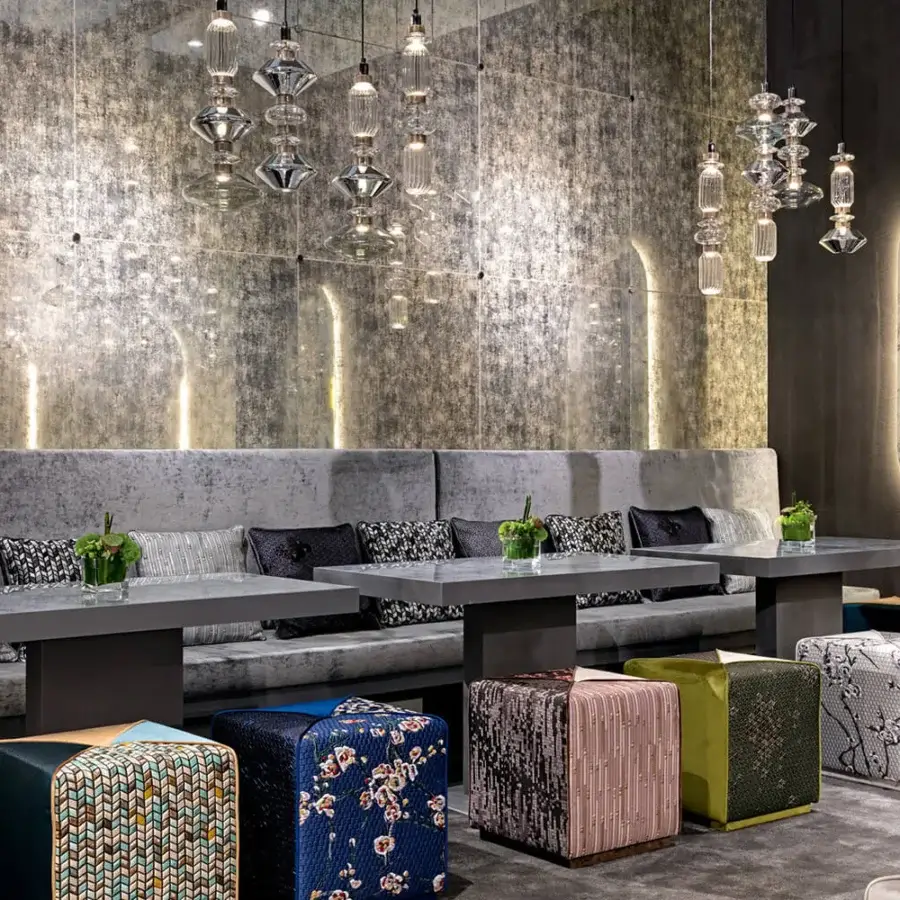 Superior Sicis Chamaleon square ottoman upholstered in multi-colored geometric fabric with a textured matte finish
