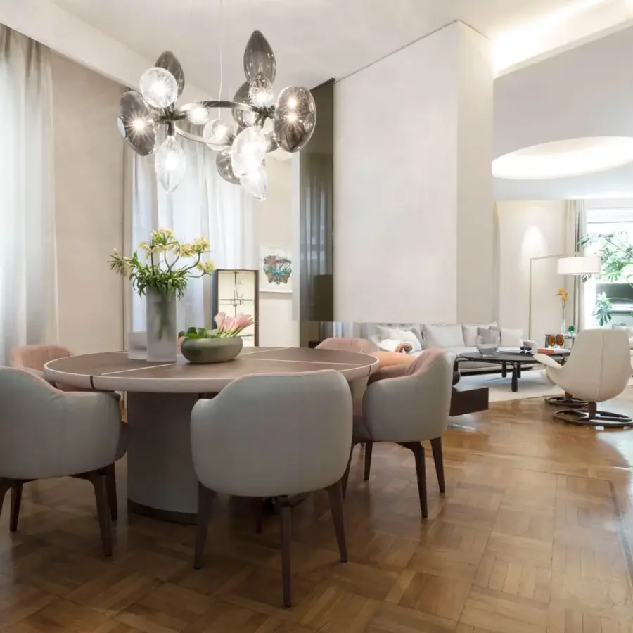 Distinguished Giorgetti Elisa armchair upholstered in light beige fabric with blush rose interior and walnut Canaletto swivel base