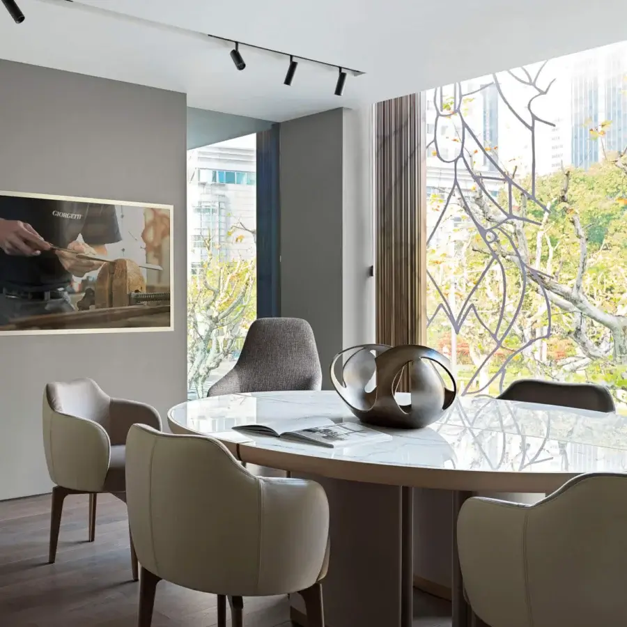 Elegant Giorgetti Elisa armchair upholstered in neutral beige fabric with a walnut Canaletto swivel base and smooth matte finish